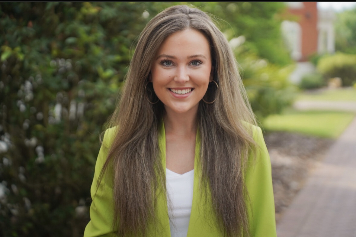 Jenna Williams wearing a green jacket